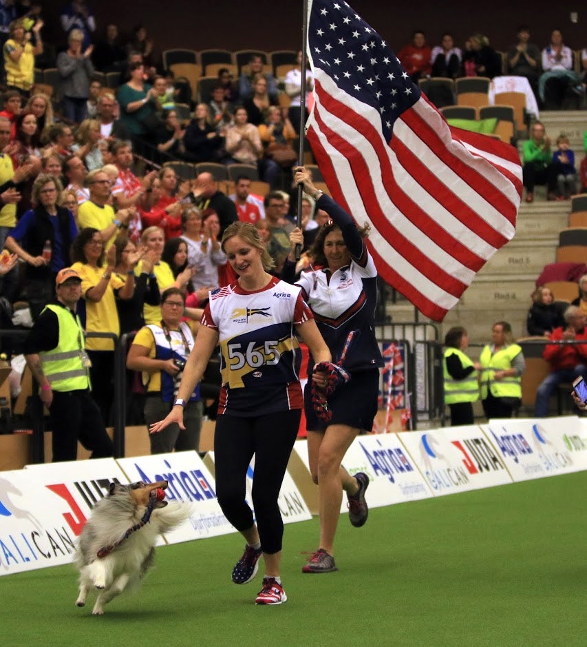 Jennifer Crank celebrates with her dog, Swift, after winning a silver medal at the 2018 FCI World Agility Championship. The duo represented the U.S. and AKC.