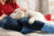 Golden Retriever puppy laying on a woman's lap in winter.
